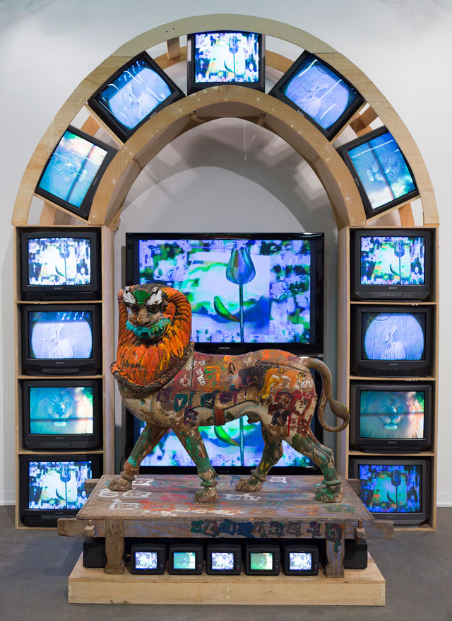 Nam June Paik, Lion, 2005. Three-channel video (colour, silent) with two plasma monitors and 26 CRT monitors and wood lion with acrylic and permanent oil marker additions, 133 x 109 x 65 in (337.8 x 276.9 x 165.1 cm). © Nam June Paik Estate. Photograph Robert McKeever. Courtesy Gagosian.