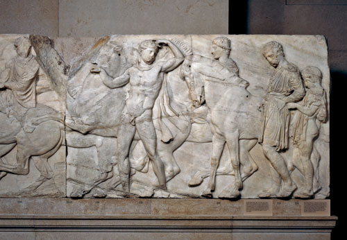 Marble relief (Block XLVII) from the North frieze of the Parthenon. The frieze shows the procession of the Panathenaic festival, the commemoration of the birthday of the goddess Athena. Designed by Phidias, Athens, Greece, 438BC-432BC. Height 101cm x width 164cm. © The Trustees of the British Museum.