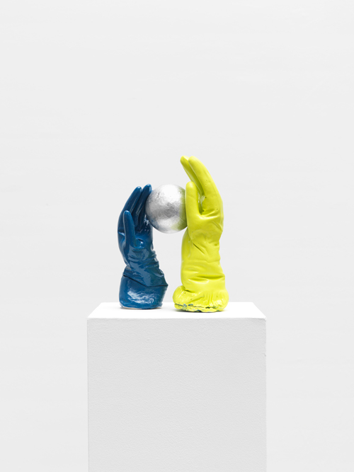 Tamar Ettun. Blue Glove with Yellow-Green Glove with a Ball, 2015. Plaster, paint, cardboard, 12 x 9 x 6 in.