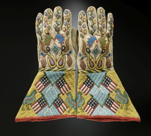 Gauntlets, c1890. Sioux-Métis artist, North or South Dakota. Native tanned leather, glass and brass beads, cotton cloth. 14 ½ x 8 in (36.8 x 20.3 cm). United States, Hirschfield Family Collection, Courtesy of Berte and Alan Hirschfield. Photograph: Hirschfield Family Collection, courtesy of Berte and Alan Hirschfield/ W. Garth Dowling. (Cat.94).