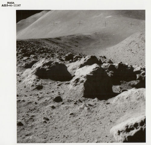 Lunar boulders, St George Crater beyond, Apollo 15, July 1971, Vintage gelatin silver print, c20 x 25cm, NASA AS15-82-11147. Courtesy Breese Little.