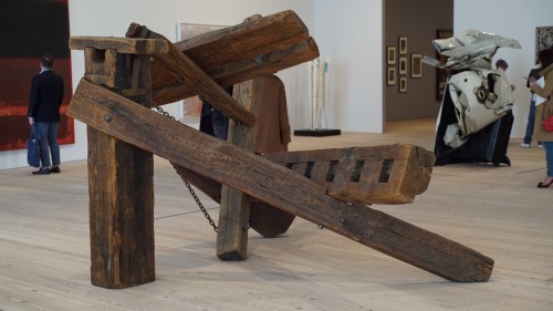 Exhibition view, including Mark di Suvero. Hankchampion, 1960. Wood, steel hardware and chains, 77 1/2 × 152 × 109 3/16 in. (196.9 × 386.1 × 277.3 cm). Whitney Museum of American Art, New York; Gift of Mr. and Mrs. Robert C. Scull. Photograph: Miguel Benavides.