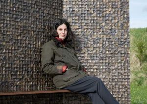 Selva Aparicio with her bronze sculpture At Rest, Nieuwpoort, Belgium, 2024. Courtesy The Artist.