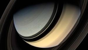 Dark side of the rings. This spectacular view looks down on Saturn’s northern regions, with its pole still in the darkness of the northern hemisphere winter. The rings cast a band of shadow across the gas giant world. Mosaic composite photograph. Cassini, 20 January 2007. NASA/JPL/Michael Benson, Kinetikon Pictures. Courtesy of Flowers Gallery.