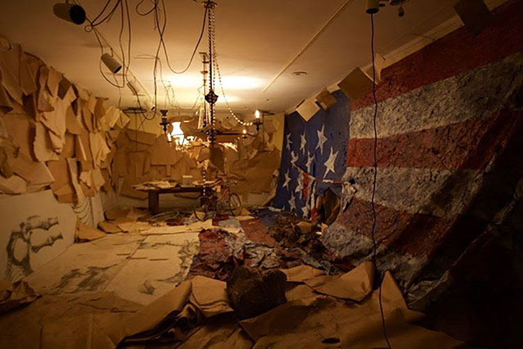 Abigail DeVille. ​Charm City Round House​, 2016. Tarps, brown paper, accumulated debris, heirlooms, found objects, bicycle, scale model of The Peale Museum, tarp version of ​The Star-Spangled Banner​, mannequins, 240 x 180 x 96 inches. Installed at the former The Peale Museum (Municipal Museum of the City of Baltimore), Baltimore. Courtesy the artist. Photo: Ginevra Shay.