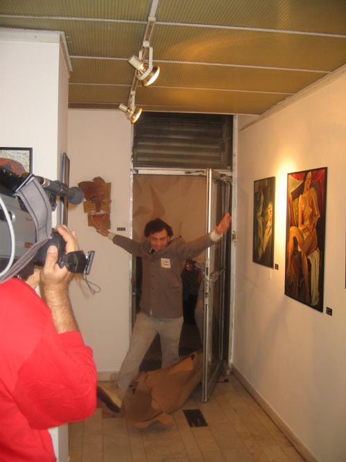 Dadadventure, September 9: Opening of the exhibition with ‘Tristan Tzara’ breaking through the brown paper door in the exhibition © Romanian Cultural Institute New York.