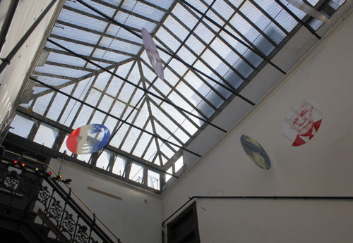 Chelsea Hotel. View of skylight and main staircase from 10th floor. Hanging artwork is an installation by Arthur Weinsten. Photograph: Miguel Benavides. © Studio International.