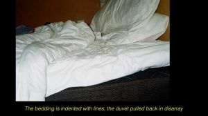 Jamila Prowse, Flare: the muted outline of a body in bed as a camera flash overtakes the scene [still], 2025.