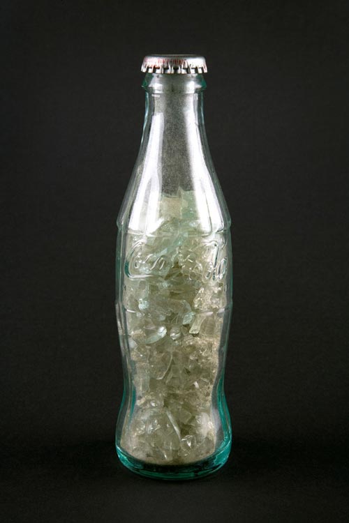 Luis Camnitzer. <em>Coca Cola Bottle filled with a Coca Cola Bottle,</em> 1973. Glass and metal, 18.2 x 5.5 x 5.5 cm. Daros-Latinamerica Collection, Zürich. Photocredit: Zoé Tempest, Zürich. © 2007 The artist