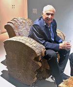Frank Gehry sitting in one of the Little Beaver cardboard armchairs he designed. Photo: Ann Philbin.