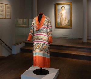 Percy Wyndham Lewis, Robe, 1913-14. Embroidered and block-printed silk robe. Background: Henry Lamb, Edie McNeill, 1911. Oil on canvas. On loan courtesy of Southampton City Art Gallery. ⁠Copyright The Artist⁠. Reproduced by kind permission of the Henry Lamb Estate. Installation view, Augustus John and the First Crisis of Brilliance, Piano Nobile, London 2024. Photo courtesy of Piano Nobile, London.