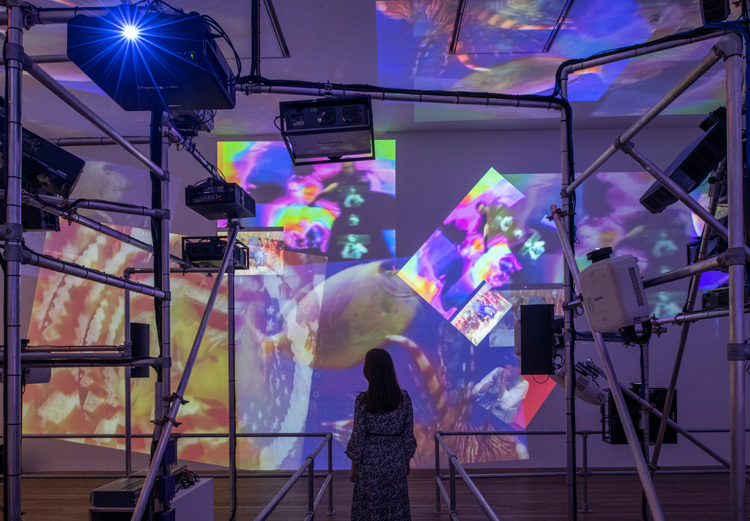 Nam June Paik. Sistine Chapel 1993. Installation view, Tate Modern 2019. Medium Video projectors, metal, wood, custom video switchers and four video channels, colour, sound. Courtesy of the Estate of Nam June Paik. Photo: © Tate (Andrew Dunkley).
