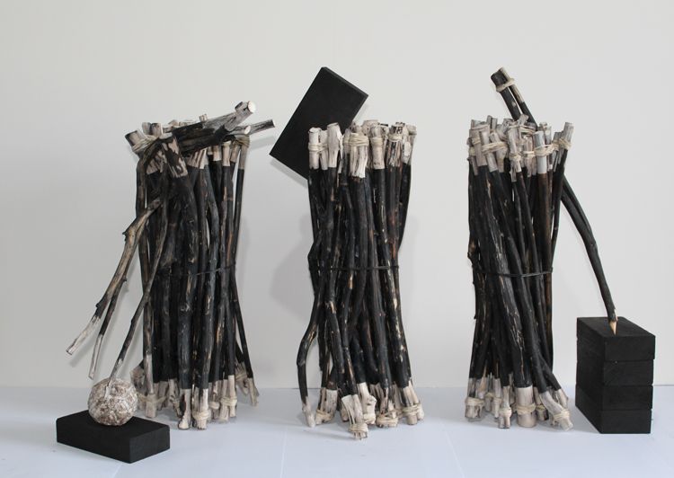 John Newling. Burnt sticks, 2020. Burnt sticks, elastic bands and charcoal blocks. Installation view, Ikon Gallery, 2020.