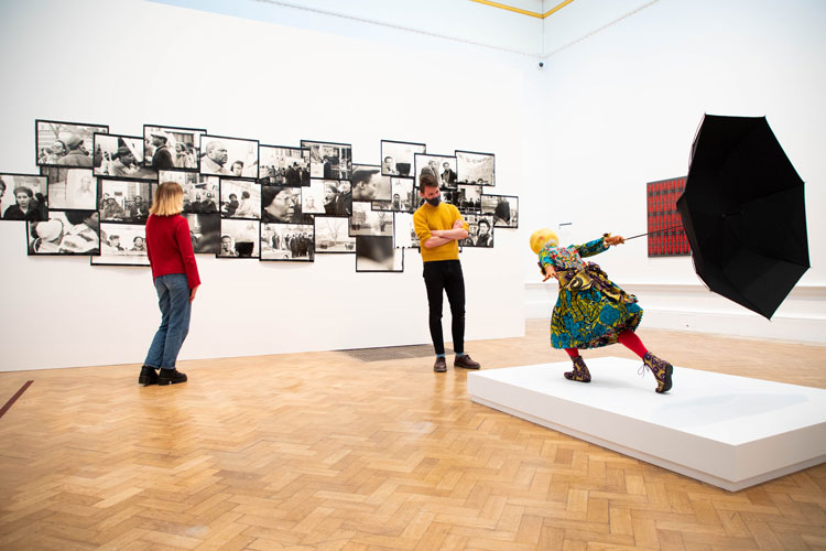 Left: Isaac Julien. Lessons of the Hour, London 1983 – Who killed Colin Roach?; Right: Yinka Shonibare. Air Kid (Girl). Installation view RA Summer Exhibition 2020. Photo: © Royal Academy of Arts / David Parry
