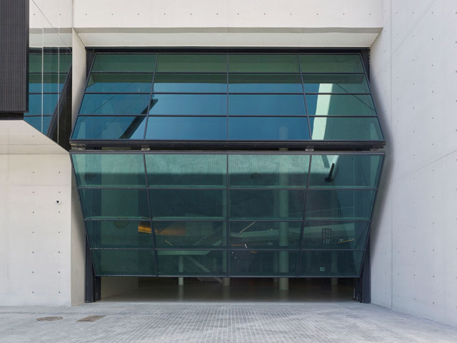The bi-folding door at the main, south-facing entrance, is 12m wide and 10m high. It is intended to be open all day and evening, enticing visitors into the building even during performances. Photograph: Didier Boy de la Tour.