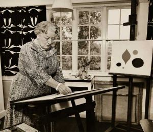 Paule Vézelay in her London studio with her 1955 textile Harmony (left) and her 1956 painting The Yellow Circle (right). Photograph, Estate of Paule Vézelay.