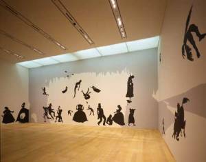 Kara Walker, <i>The Hot Black Road to Freedom, a double-dixie two-step 
        (Detail)</i>, 2005. Cut paper and adhesive on wall. Collection of the 
        artist and Brent Sikkema, New York. Installation view: The World is a 
        Stage: Stories Behind Pictures. Photo: Kioku Keizo. Photo courtesy: Mori 
        Art Museum